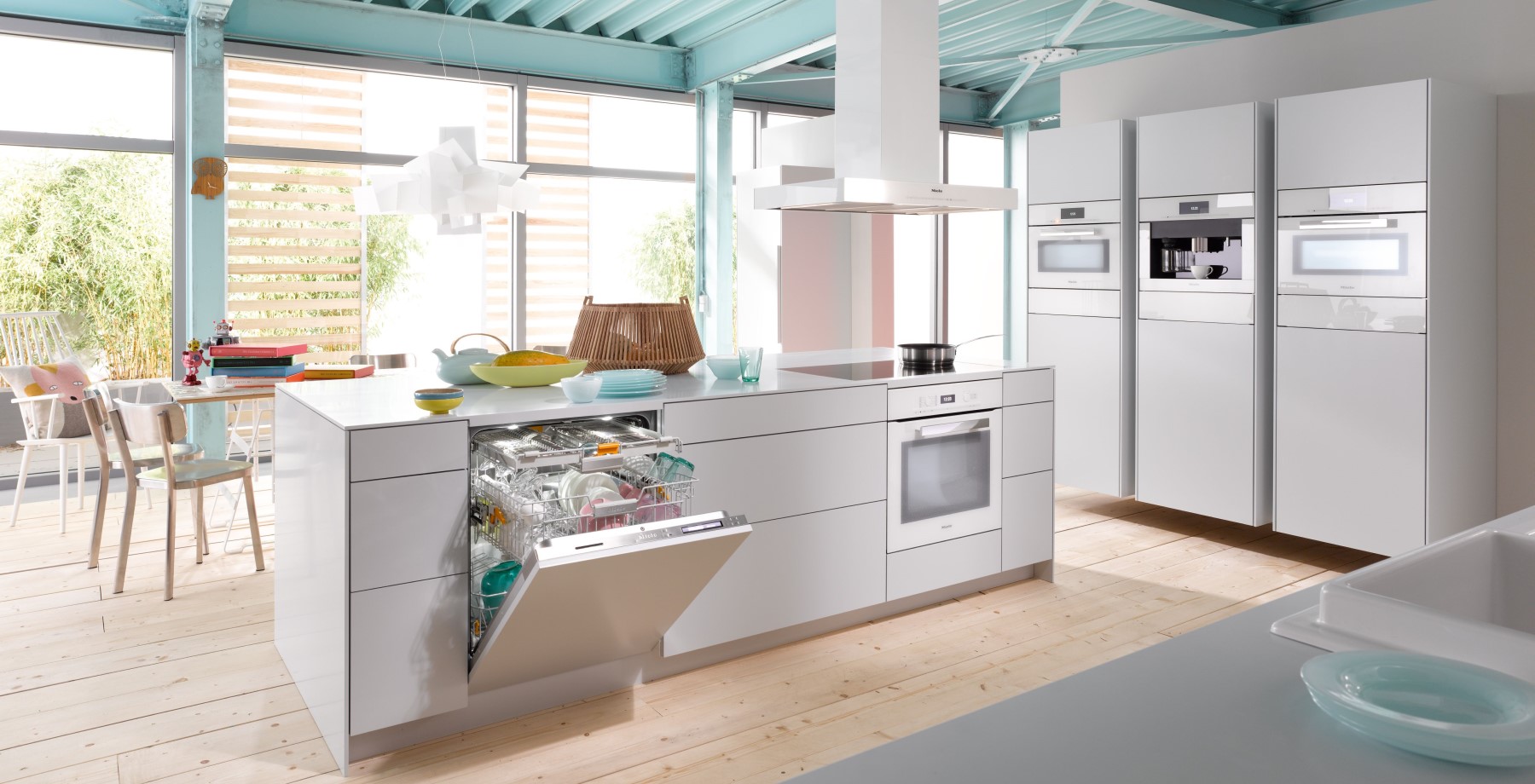 Miele built-in oven, warming drawer and coffee system installed in a kitchen wall