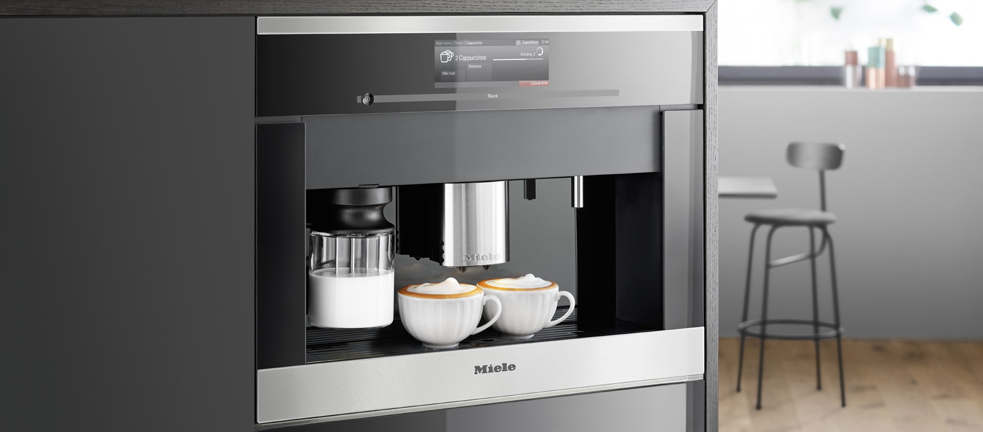 Miele built-in coffee machine dispensing two cappuccinos